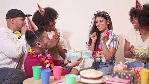 Friends Celebrating Birthday Together with Gifts and Cake