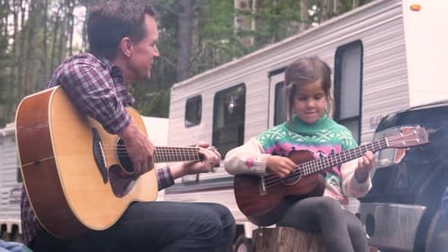 Father and Daughter Sing in Woods