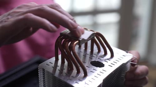 Closeup Cropped Shot of Unrecognizable Man Removing Old Thermal Paste with Wet Napkin From Cooler of