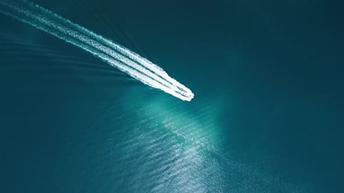 Speed Boat Cuts Through Blue Ocean Water