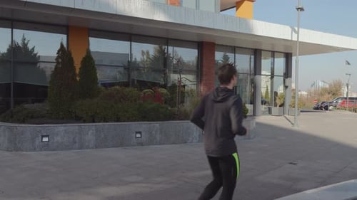 Young Man Jogging Outdoors in an Urban Area Maintaining a Healthy and Active Lifestyle