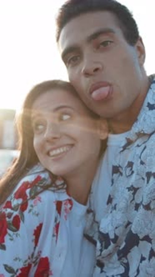 Playful Couple Posing for Fun Selfie in Daylight