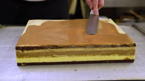 Chef Spreads Caramel on Layered Cake