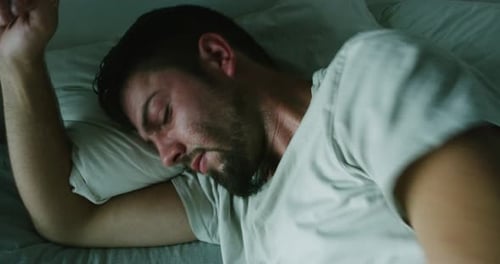 Man Sleeping Peacefully at Night in His Bed