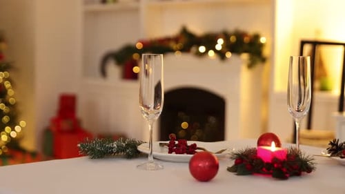 Christmas table setting decorated with ornaments and candle