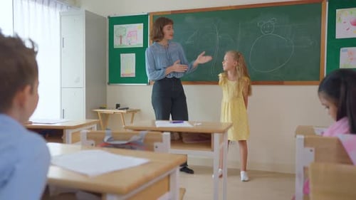 Caucasian schoolgirl student dancing in front of classroom at school.