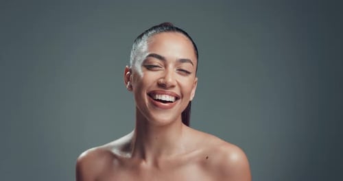 Laugh, happy and skincare with face of woman in studio for self care, beauty and shine