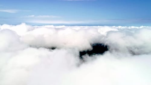 Drone shot flying through amazingly beautiful cloudscape. Picturesque view of white fluffy clouds mo