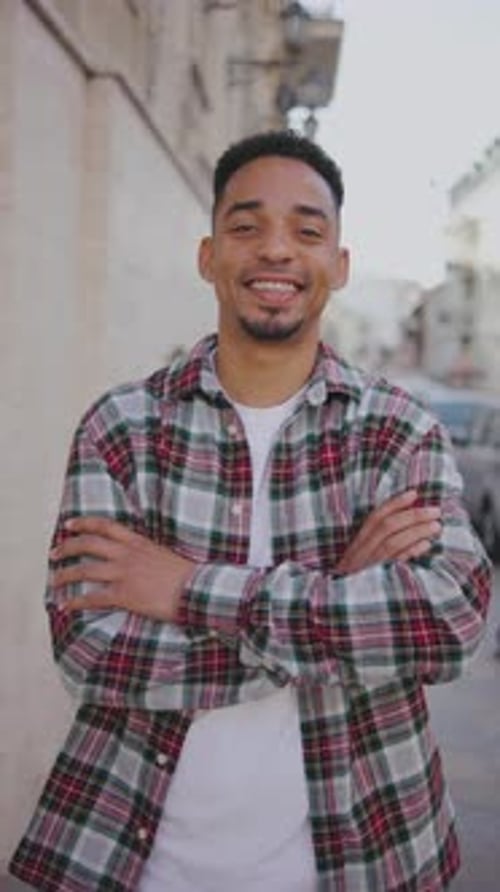 Vertical Portrait of a Young African American Man on the Street A Young Guy Stands on the Street and