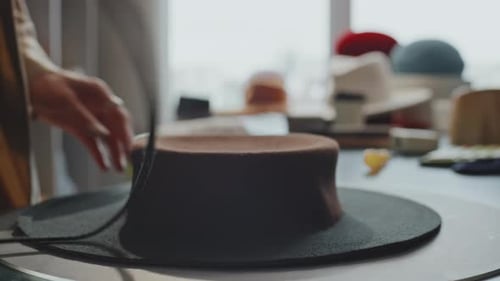 Milliner Shaping a Hat in Workshop