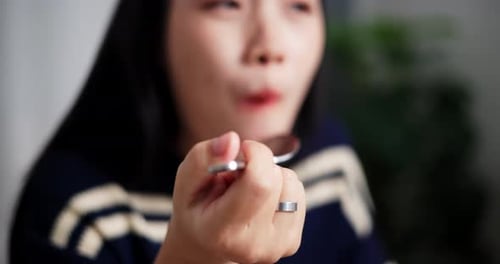 Close up of Woman Eating Food with Spoon