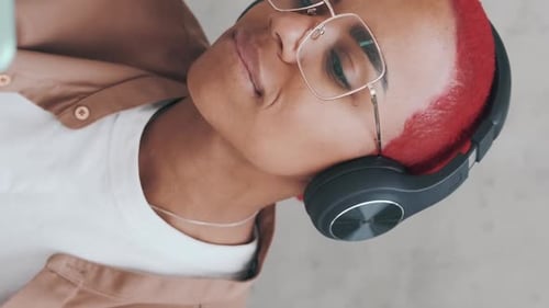 Young Adult with Red Hair Using Smartphone