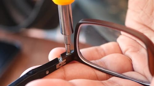 Repairing Eyeglasses with a Screwdriver, Close Up