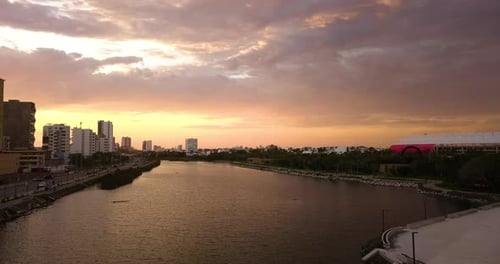 Sunset air view of a river that passes through an urban area