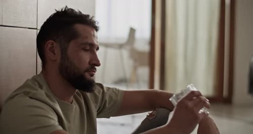 Bearded Young Adult Drinking from Glass