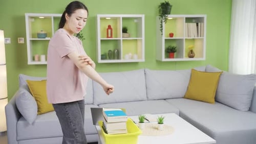 Woman Massaging Sore Wrist and Arm