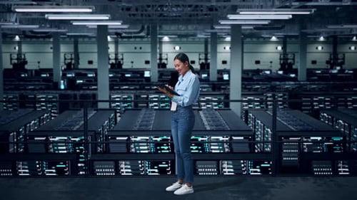 Side View Of Full Body Asian Business Woman Using Tablet In Data Center