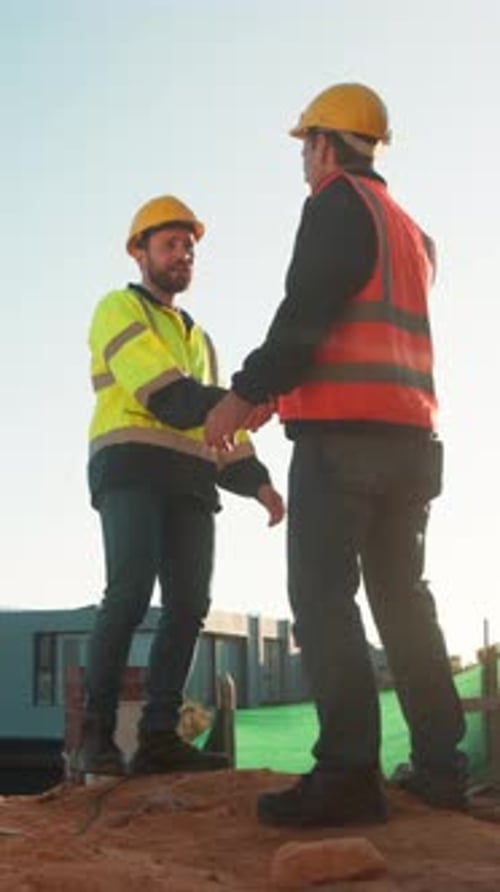 Construction site, team and handshake with men for partnership, introduction and thank you
