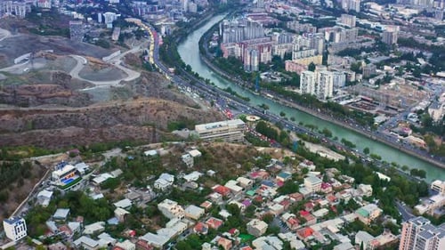 Aerial view of Tbilisi cityscape, mountains and Kura river