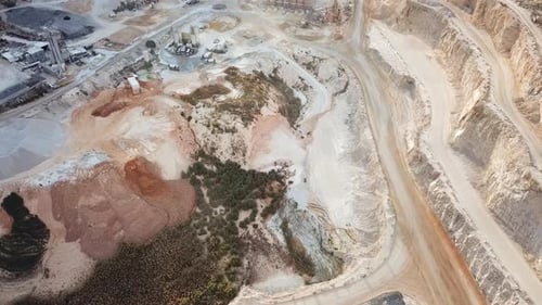 Stone sorting station in a large Quarry, with rocks transported on conveyor belts, Aerial view.
