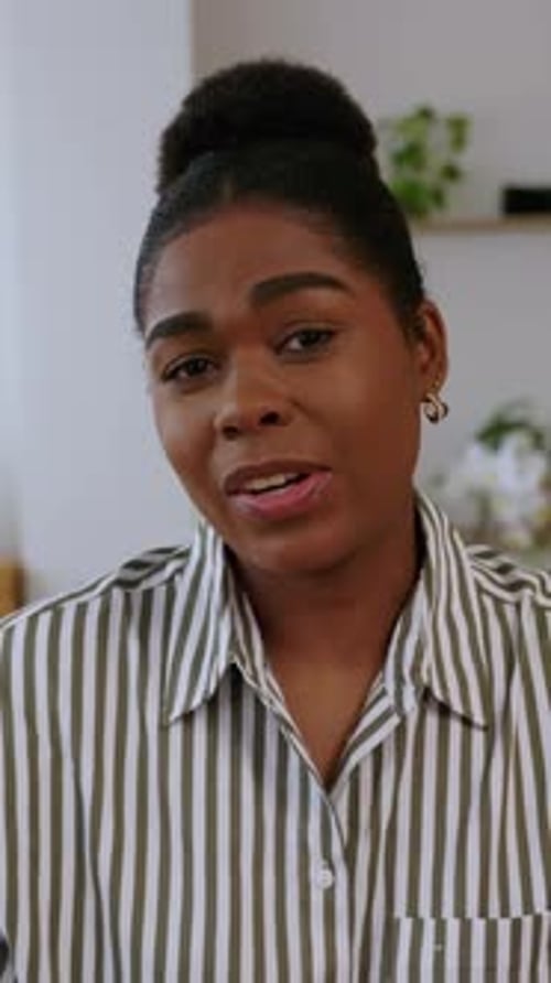 Woman Smiling and Talking Wearing Striped Shirt