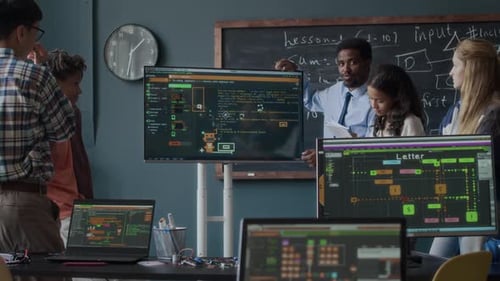 Programming Teacher Explaining Software Development to Teenage Students in Class