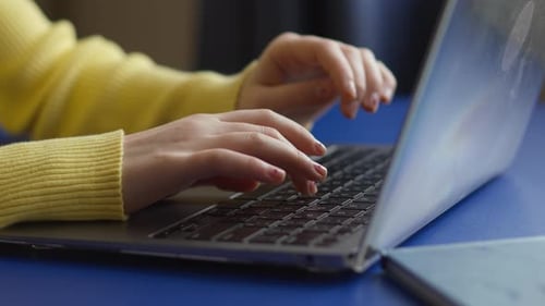 Close Up of Hands Typing on Laptop Keyboard