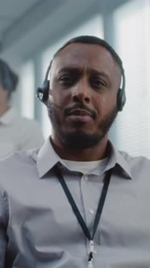 Man Wearing Headset Communicating in an Office