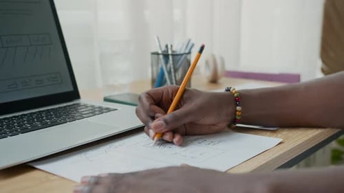 Designer Drawing Website Sketch on Paper