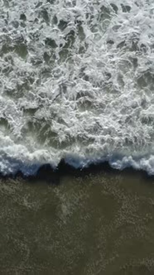 Vertical Video of Ocean Waves Rolling On Shoreline