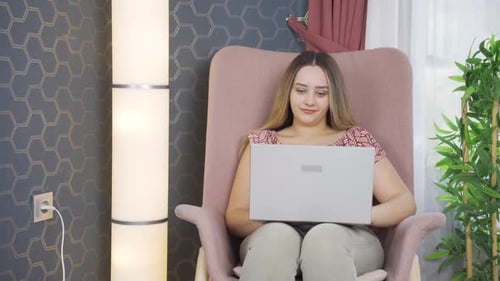 Young Woman Working on Laptop at Home