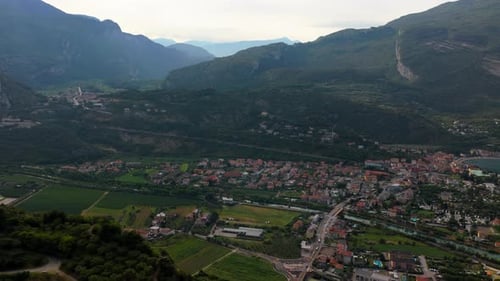 Camera fly back revealing panoramic view of town on Lake Garda surrounded by mountains