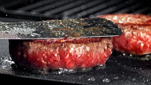 Burger Patty Sizzles on a Hot Grill