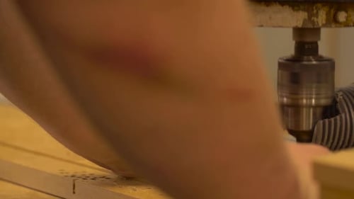 Woodworking Machine Drilling Holes in Lumber, Close Up