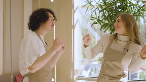 Two Waiter Woman and Man Dances in a Cafe A Cafe Worker in a Good Mood Dances to Music During a