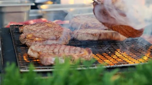 Raw Beef Steak is Being Roasted on the Grill Pan Outdoors