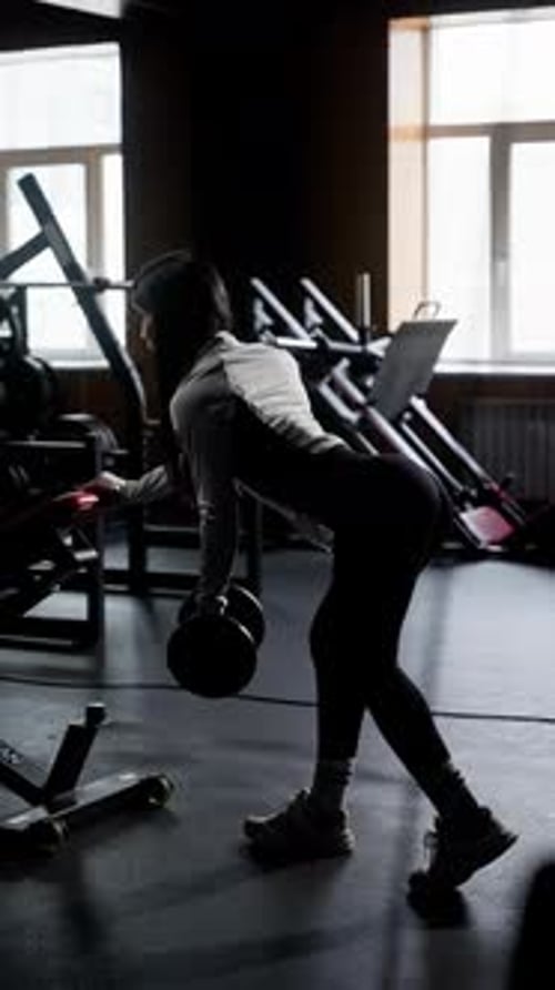 Focused Athlete Performing Deadlifts at Gym Woman in Gym Gear Executes Deadlifts with Precision
