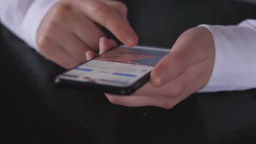 Young Man Look in Mobile Phone and Browse Social Network Close Up