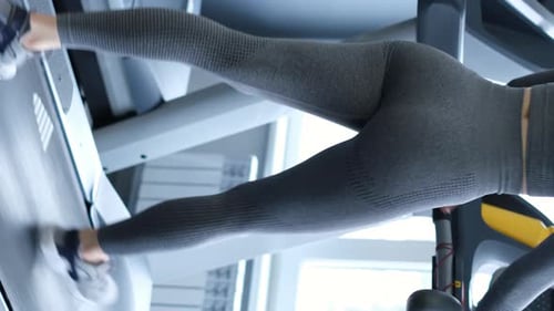 Vertical Video Sexy Girl is Doing Cardio Training on the Treadmill in the Gym Sport Concept