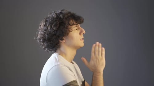 Rebellious young man praying.