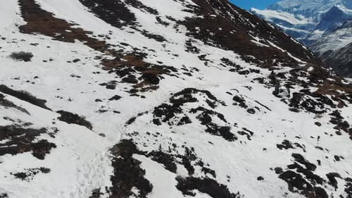 Drone shot of snow on a hill in Annapurna Circuit Trek in Manang, Nepal.