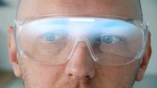 Man wearing smart glasses displays coding on lenses in a future technology concept