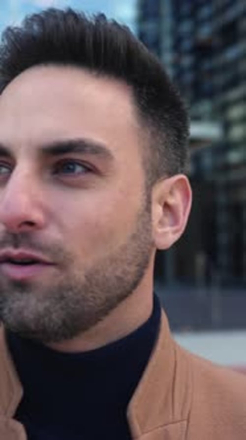 Young Businessman Talking on Mobile Phone While Standing Over Business Office