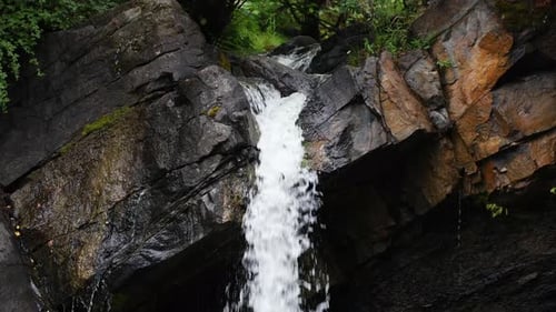 Serene Waterfall Cascading Over Rocks. Alberta, Canada.