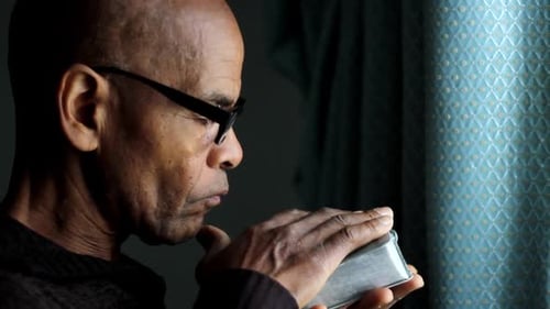 Adult Man Contemplating Object in Close Up Shot