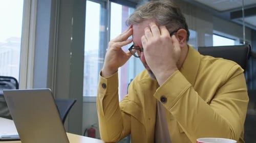 Stressed Manager Working Hard in Office