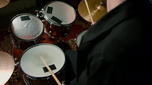 drummer plays a drum kit in a recording studio at a professional musician rehearsal recording a song