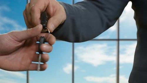 Businessman Passes Car Key