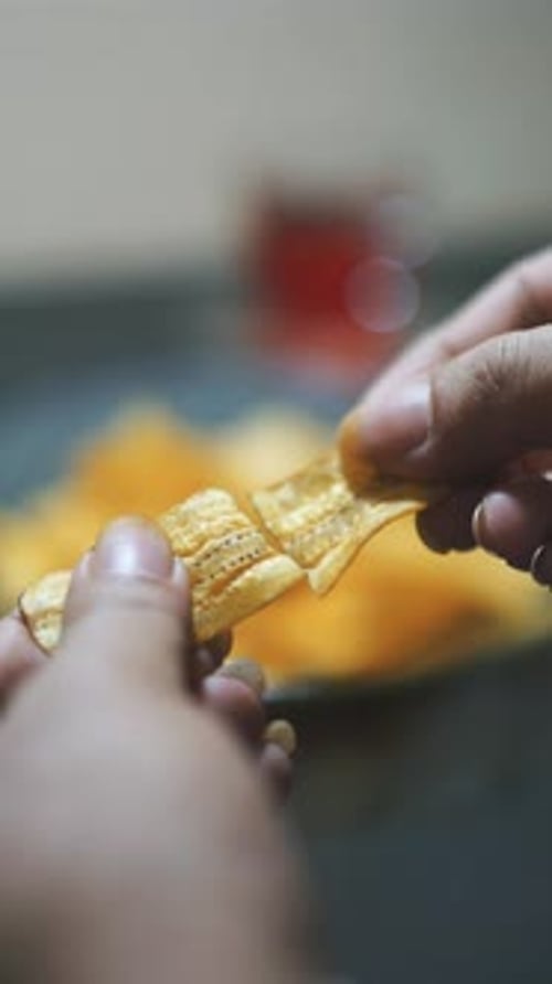 beautiful vertical video portrait banana chips on a plate with a black table mat