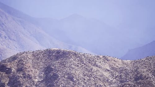 Mountains and Hills Create an Expansive Landscape Under a Hazy Sky